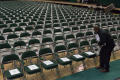 Photograph: [Man Setting Up Chairs for Fall 2014 Undergraduate Commencement Cerem…