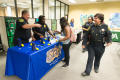 Photograph: [Police officers shake student's hand the LGBTQIA Career Fair, 4]