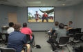 Thumbnail image of item number 1 in: '[Students watch video game simulation]'.