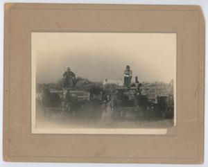 Primary view of object titled '[Two men with their wheat harvest]'.