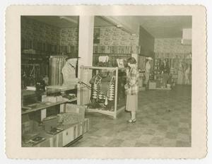 [Photograph of Myres and a woman inside his shop]
