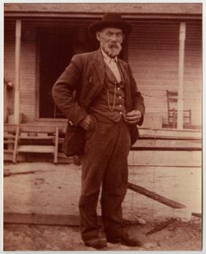 [Photograph of a man in a suit]