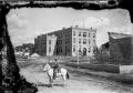 Photograph: [Man on Horse in Front of Building]