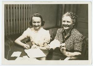 Primary view of object titled '[Two Women at Desk]'.