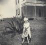 Primary view of [Lillie Dew in front of the Dew House]