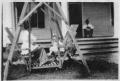 Photograph: [Lillie Dew and Mantie Dew in a Glider Swing]