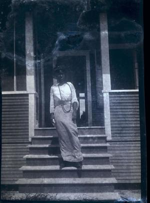 [Woman Standing on the Steps of a House]