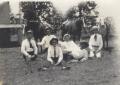 Photograph: [Six Men Sitting on the Ground]