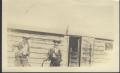 Photograph: [Men in front of House]