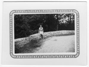 Primary view of object titled '[Unidentified Woman Sitting on a Wall]'.