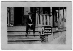 Primary view of object titled '[Unidentified Man Sitting on Porch]'.
