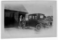 Photograph: [Unidentified People Standing Next to a Car]