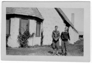 Primary view of object titled '[Two Unidentified Men Standing in front of the Church of St. Mary]'.