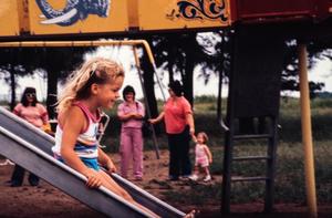 Primary view of object titled '[Girl on a Slide at North Lakes Park]'.