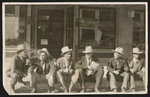 Primary view of object titled '[Cattlemen on Curb in Carlsbad]'.
