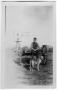 Photograph: Man with a Dog Sitting on Wagon