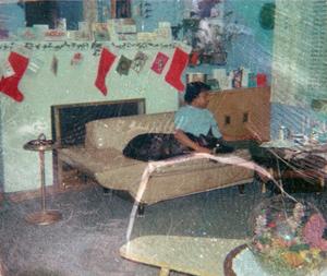 Young woman and dog in living room decorated for Christmas