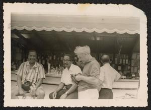 Gus Johnson, Norman Granz, and others at a bar