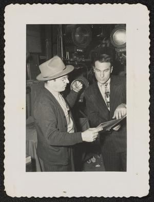 Unidentified man and Norman Granz in front of stage lights