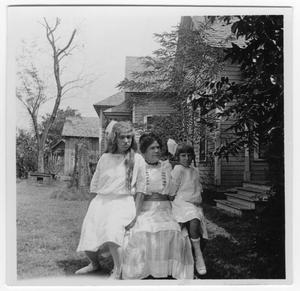 Unidentified Woman and Two Unidentified Girls in Front of a Frame House