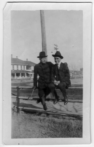 [Wilton Cook and Lee Preston sitting on a fence]