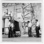 Photograph: Four Unidentified Men Talking at a Power Plant