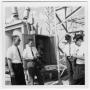 Photograph: Four Unidentified Men Talking at a Power Plant