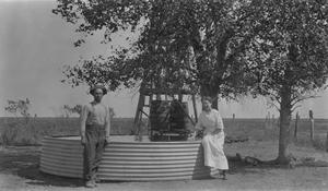 Primary view of object titled '[E. D. and Kay Palm at a Water Tank]'.