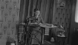 Primary view of object titled '[Bettie at a Sewing Machine]'.