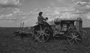 Primary view of object titled '[Farmer on a Tractor]'.