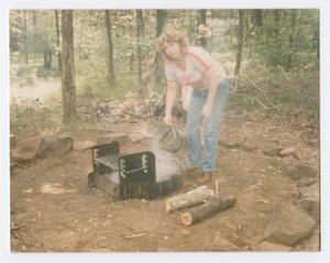 [Woman Dousing a Campfire]