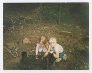 Primary view of object titled '[Two Girls Next to a Fire Pit]'.