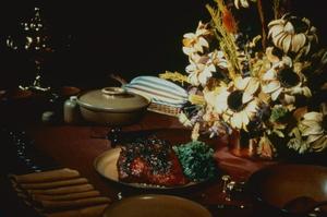 [Formal place setting with steak and flowers]