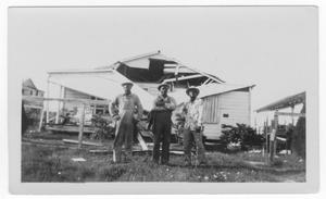 [Three men in front of a damaged house after the 1947 Texas City Disaster]