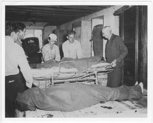 [At the temporary morgue for victims of the 1947 Texas City Disaster]
