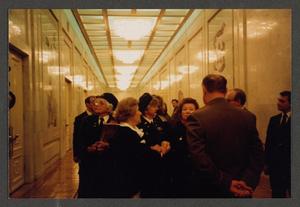 Primary view of object titled '[Charlyne Creger and Others in a Hallway]'.