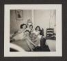 Photograph: [Four Young Women Gathered on Bed]