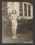 Photograph: [Woman by a House]