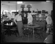 Photograph: [Man in a Furniture Store]