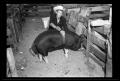 Photograph: [Man with a Pig, Cleveland Dairy Days]