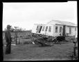 Photograph: [Man Standing by Wreckage]