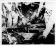 Photograph: [Rescue workers remove a body from debris after the 1947 Texas City D…
