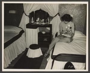 [Woman Sitting on a Bed]