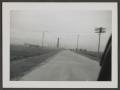 Photograph: [Road with Structure in the Distance]