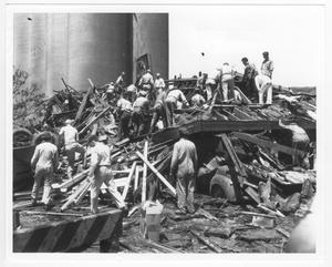 [Rescue workers search for survivors at the Texas City Terminal building after the 1947 Texas City Disaster]