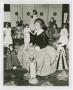 Photograph: [Woman Surrounded by Page Boy Dolls]