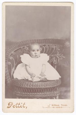 [Unknown Small Baby Sitting on Wicker Furniture]