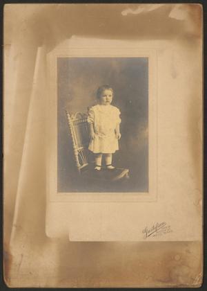 [Unknown Small Child Standing on Wicker Chair]