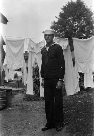 [Sailor Standing in Front of a Hanging Laundry]