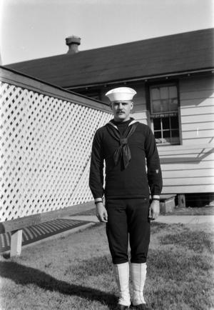 Primary view of object titled '[Sailor in Front of a Building]'.